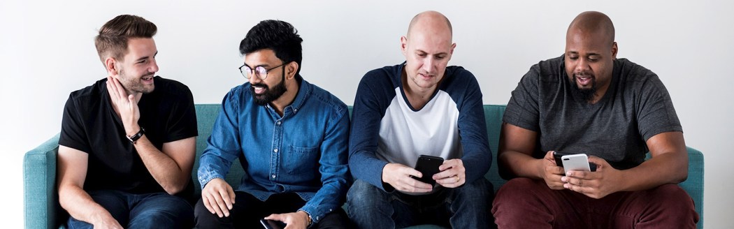 Men With Phones On Sofa